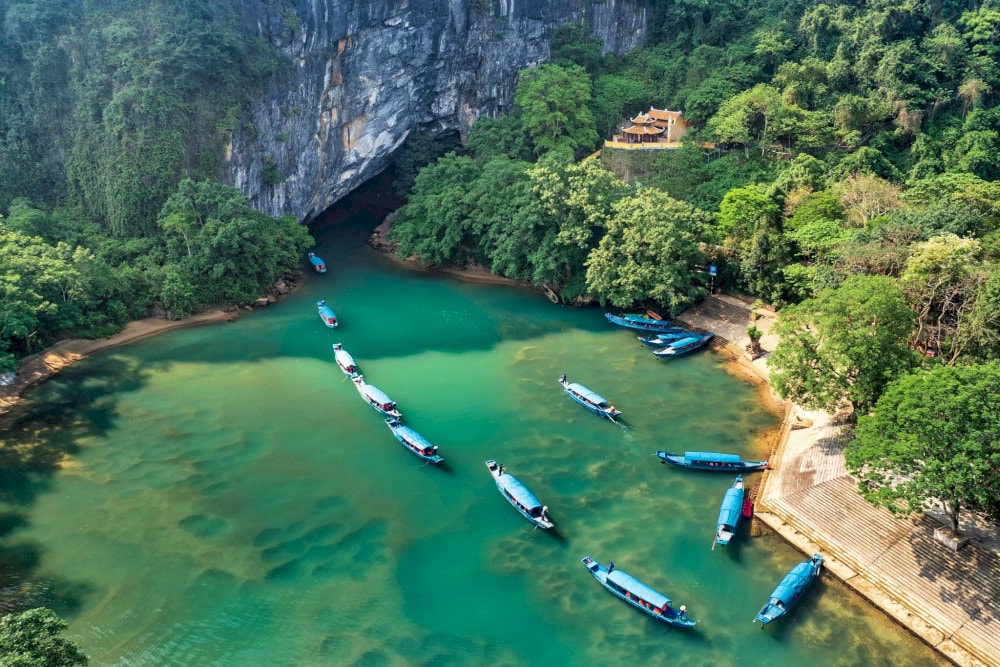 The crystal-clear water and limestone mountains flanking the river create a peaceful ambiance
